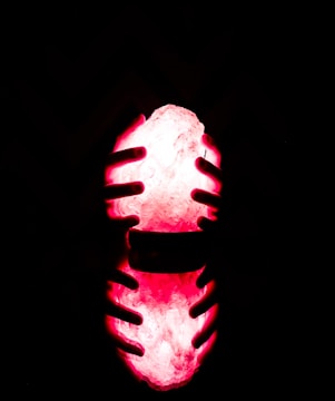 Close-up of hands holding digital tokens glowing with energy.