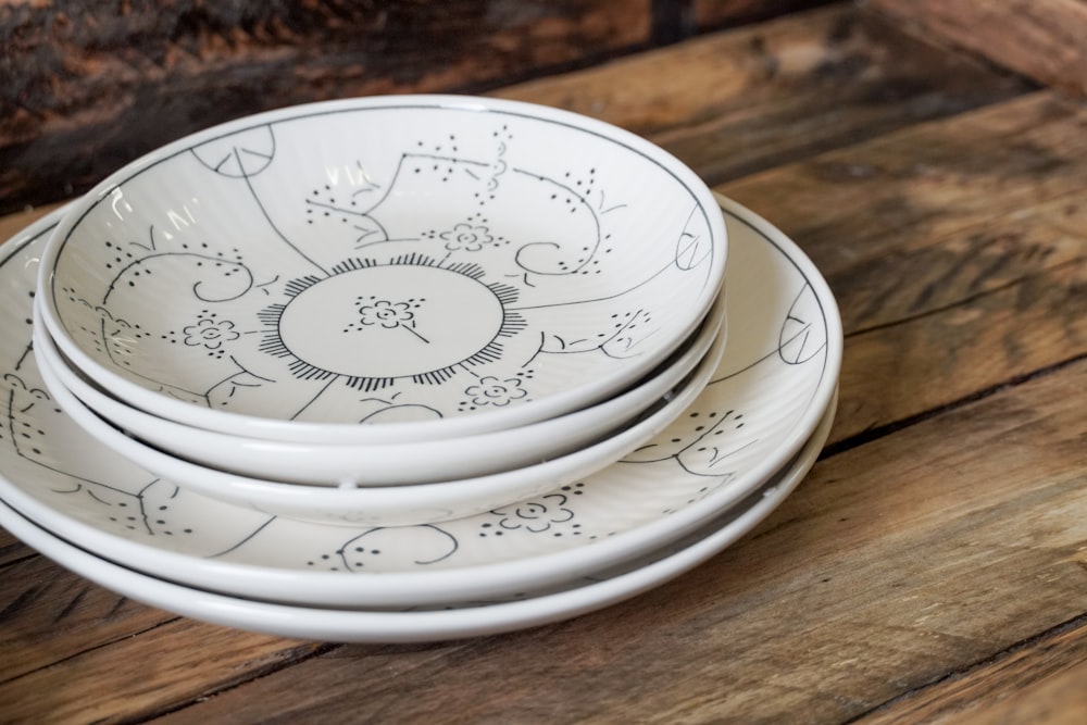 white ceramic round plate on brown wooden table