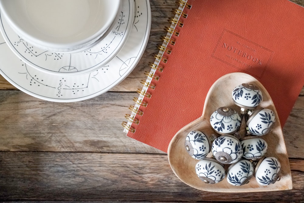 white and blue ceramic bowls on brown wooden tray