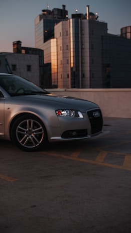 A well-maintained rental car parked at a busy urban location at sunset.