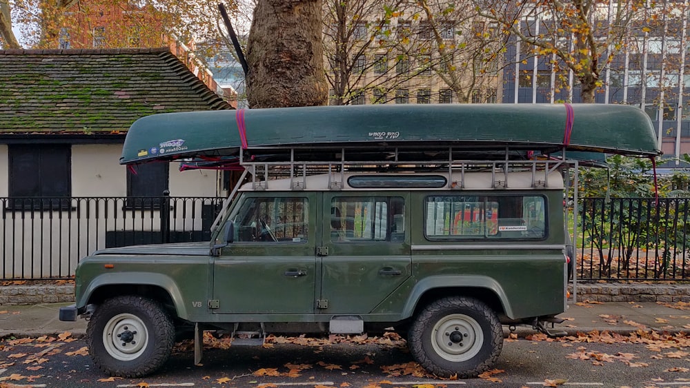 green and white suv near bare trees during daytime