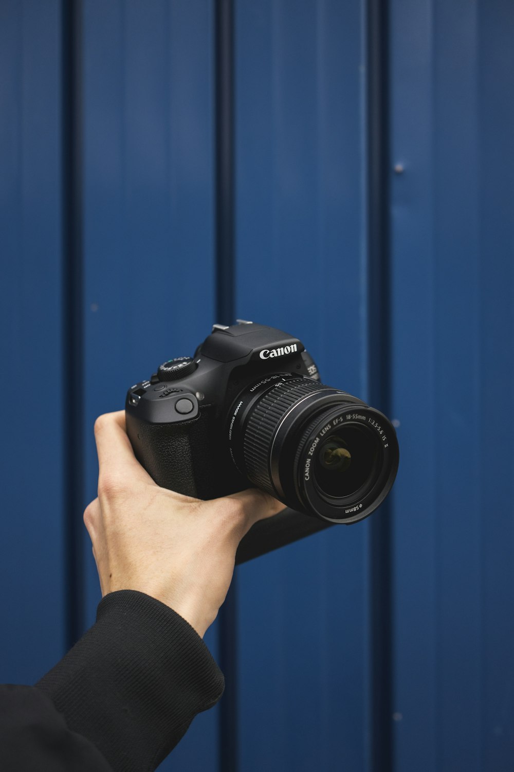 person holding black nikon dslr camera