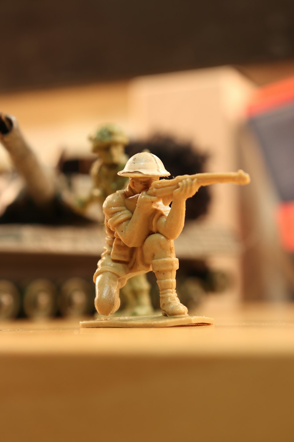 man in brown coat and hat holding rifle figurine