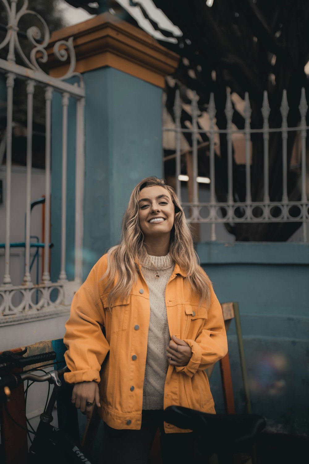 woman in brown coat sitting on bench