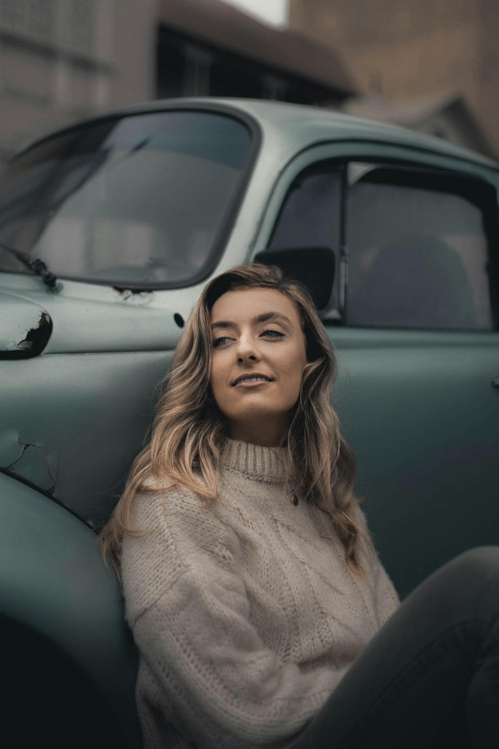 woman in white knit sweater smiling