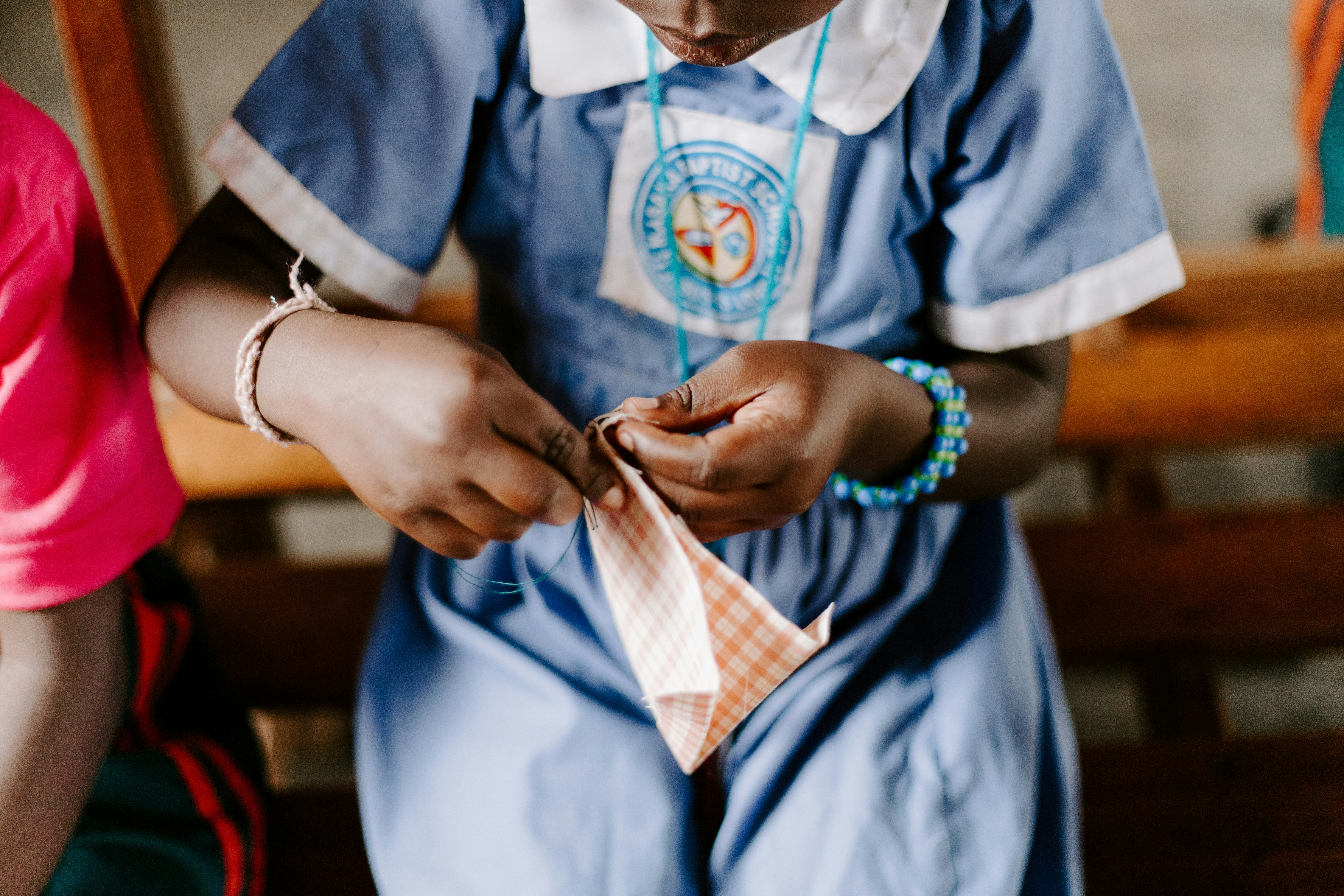 man in blue and white button up shirt holding brown and white plaid textile