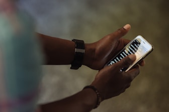 person holding black and white smartphone