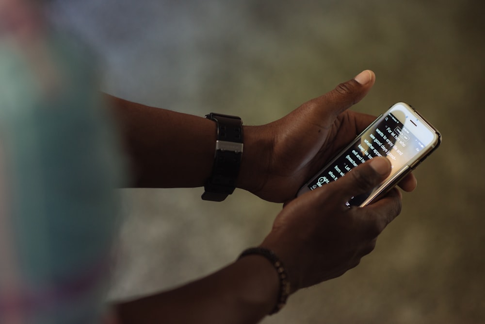 person holding black and white smartphone