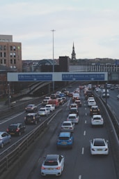 cars on road near bridge during daytime