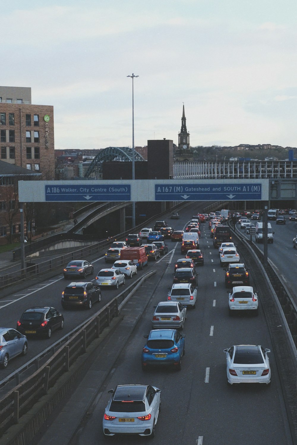 cars on road near bridge during daytime