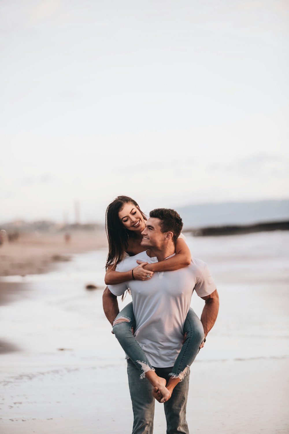 man in white t-shirt and blue denim jeans hugging woman in white t-shirt on on on on on