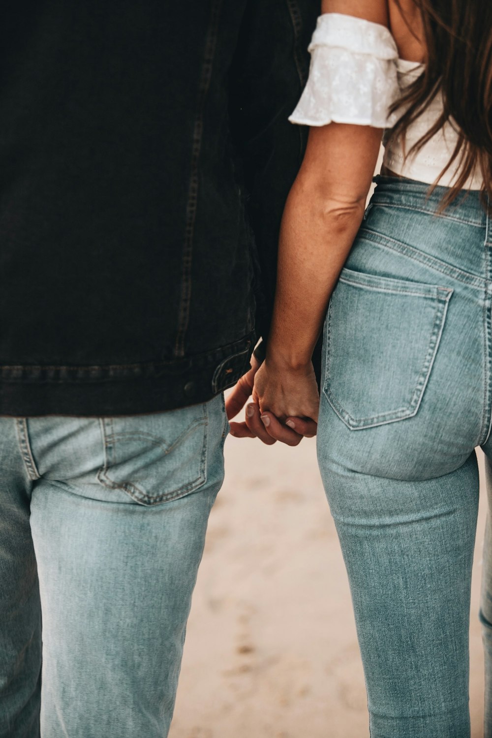 woman in black tank top and blue denim jeans