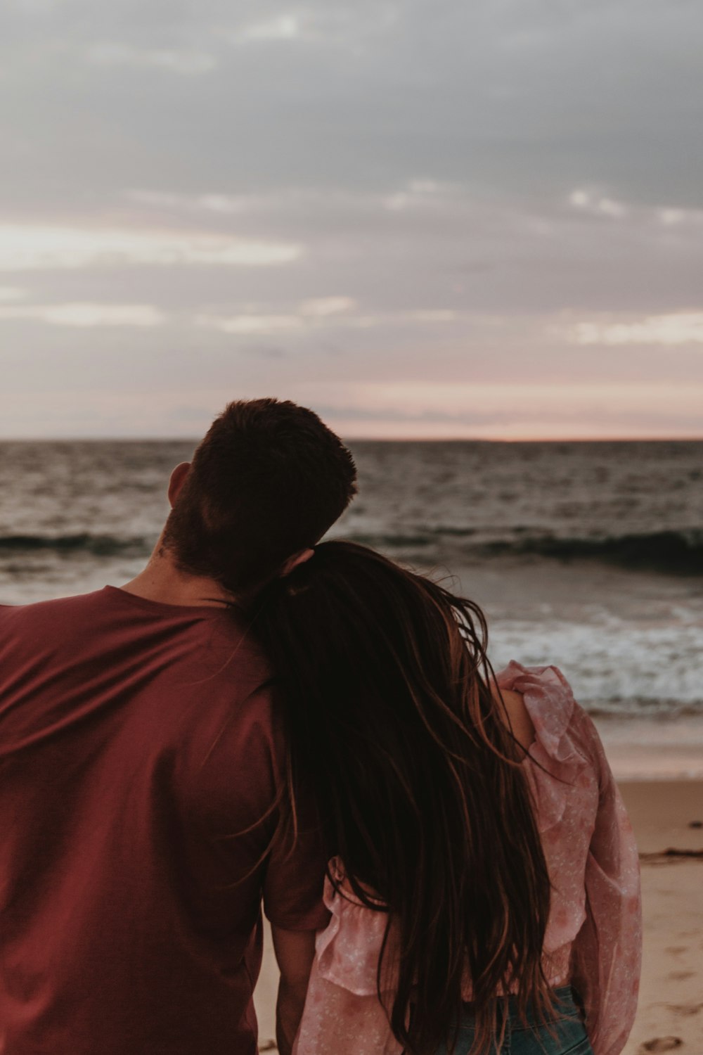 man and woman standing near sea during daytime