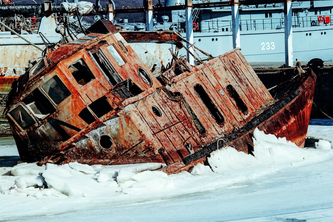 brown and black metal ship on white snow covered ground during daytime