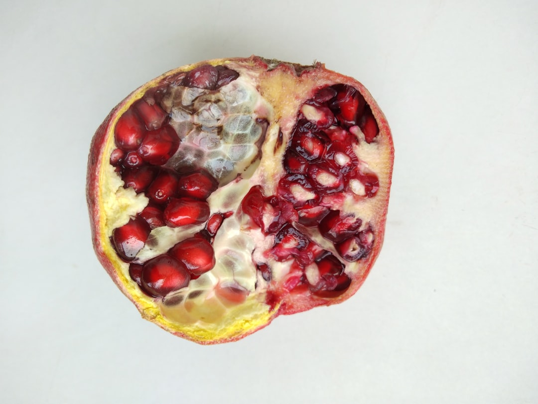 red and yellow fruit on white surface