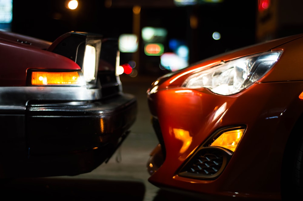 red and black car on road during night time