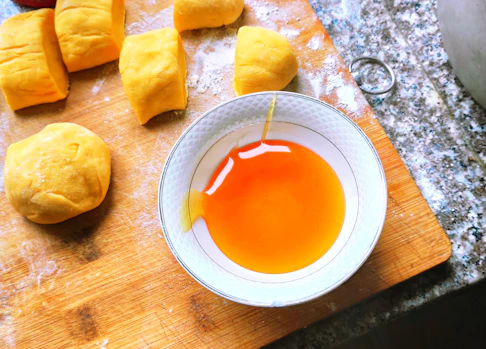 orange liquid on white ceramic bowl