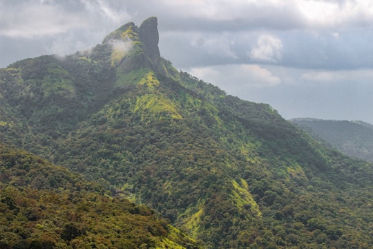 green and gray mountain under white clouds during daytime in Lonavala India