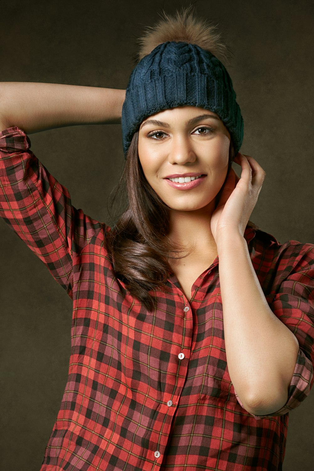 woman in red and black plaid button up long sleeve shirt and blue knit cap