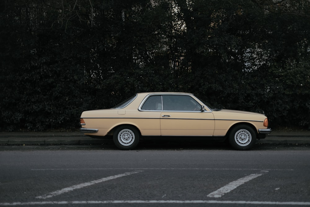 yellow coupe on gray asphalt road during daytime