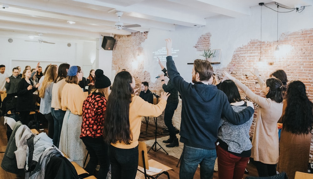 people standing and sitting on chairs