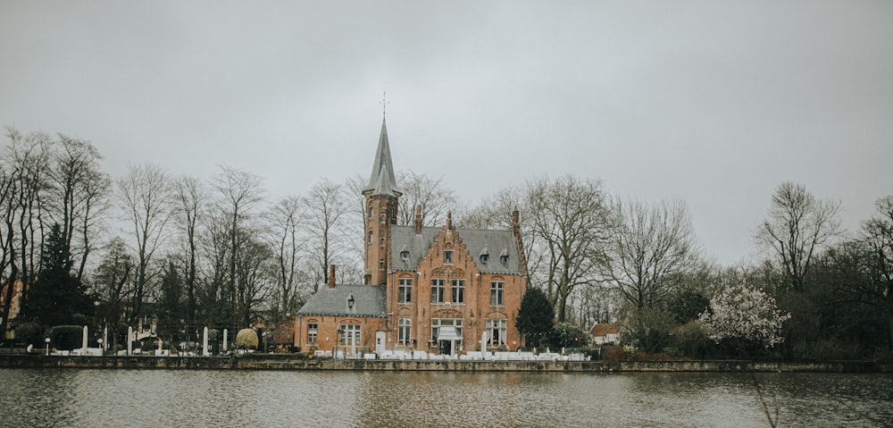 brown and gray concrete building near body of water during daytime