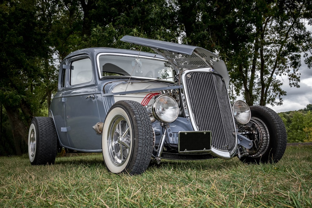 black vintage car on green grass field during daytime