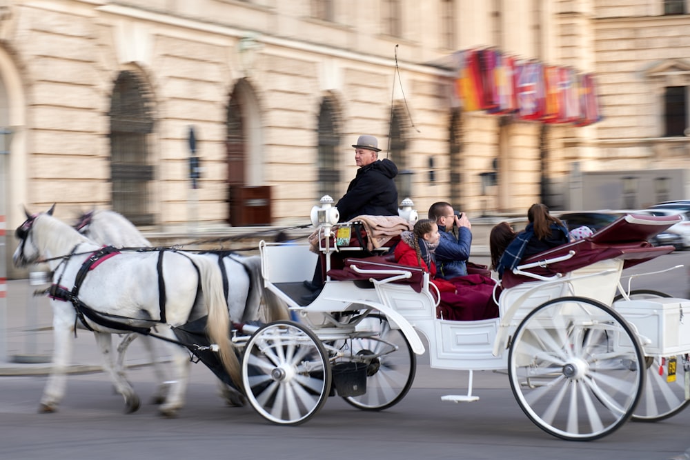 people riding horses on street during daytime