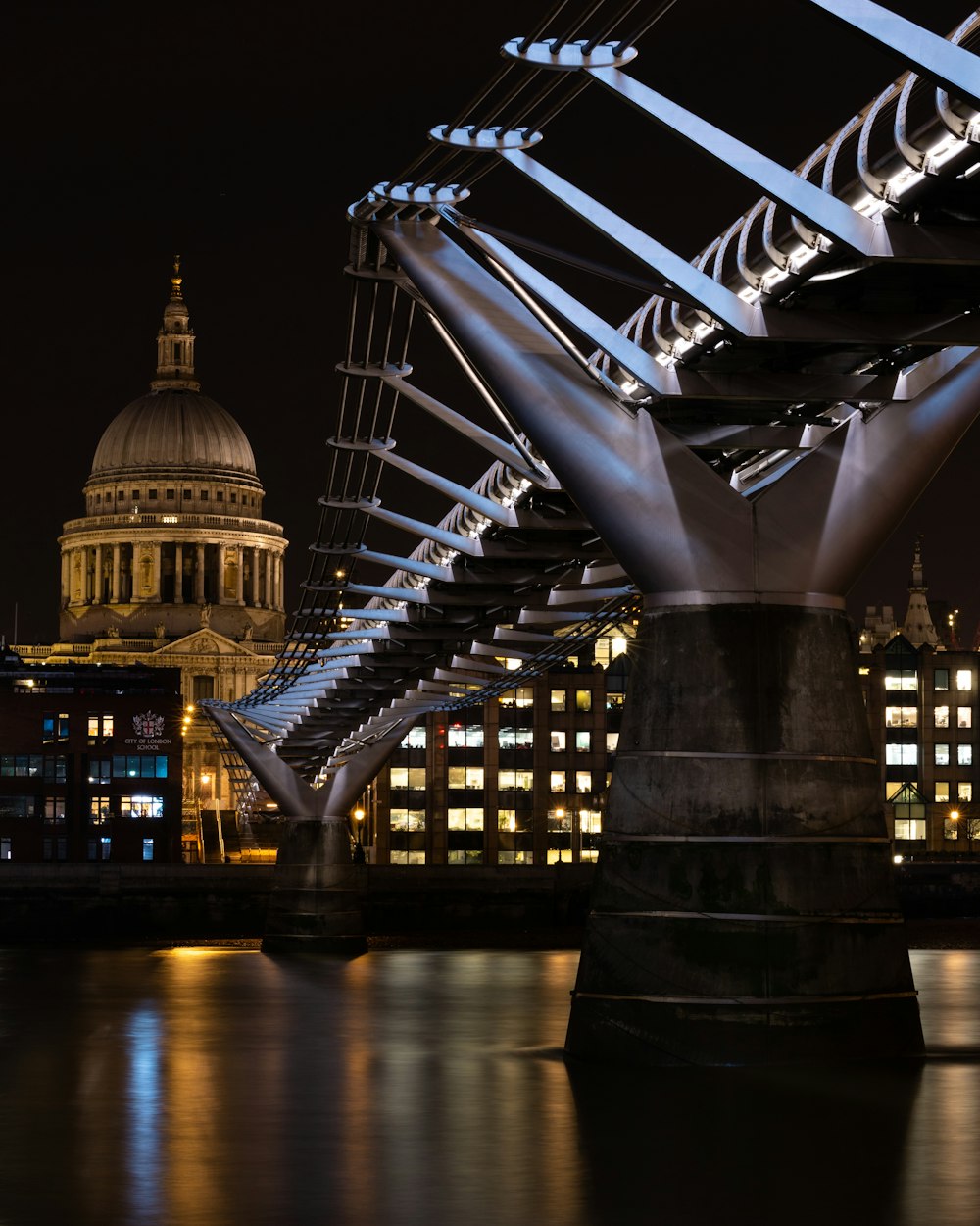 lighted bridge over river during night time