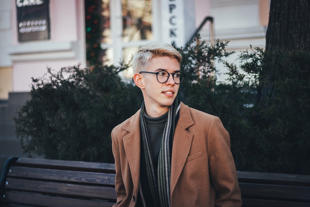 man in brown suit jacket wearing black framed eyeglasses