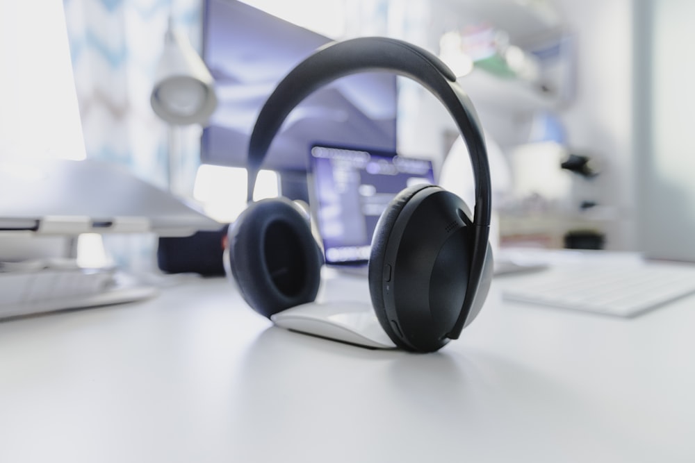 black and gray wireless headphones on white table