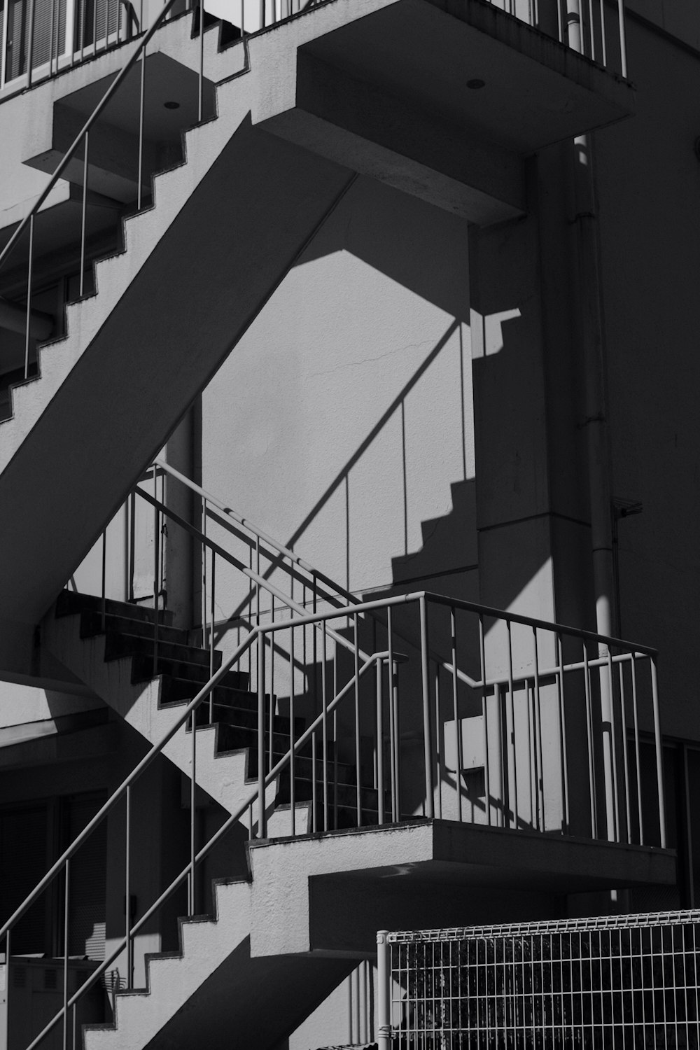 grayscale photo of spiral staircase