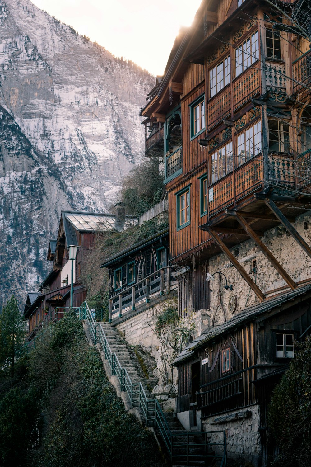 brown wooden house near mountain during daytime