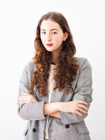 woman in gray cardigan and black and white striped dress