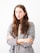 woman in gray cardigan and black and white striped dress
