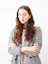 woman in gray cardigan and black and white striped dress