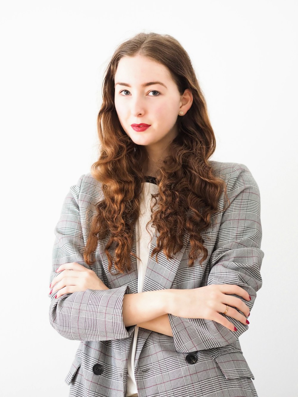 woman in gray cardigan and black and white striped dress