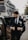 man in black suit jacket and black pants sitting on black car