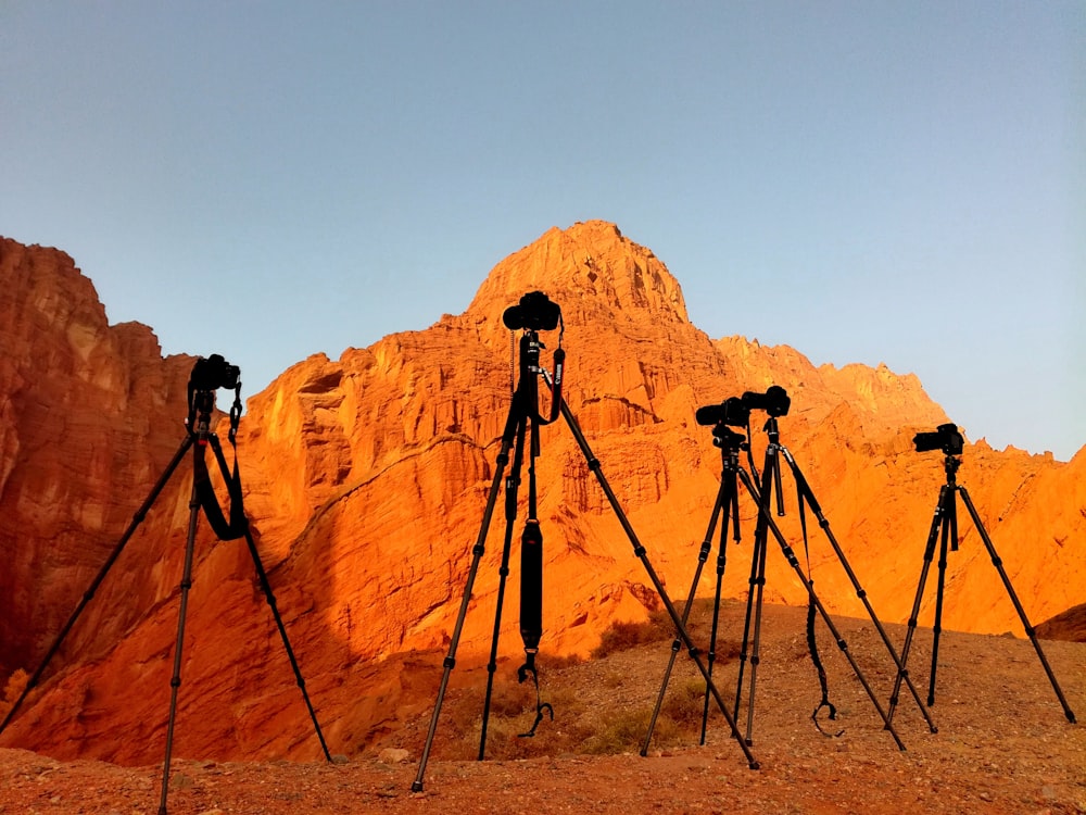black camera on tripod on brown rock formation during daytime