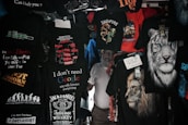 A variety of T-shirts are displayed with humorous and bold text designs, featuring phrases like 'I don't need Google,' and graphics such as lions and tigers. The T-shirts are predominantly dark with bright text and images.