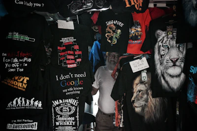 A vibrant display of t-shirts, hoodies, and hats showcasing crazy sayings.