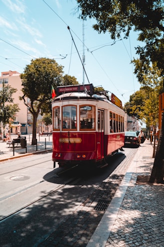red and white tram on road during daytime