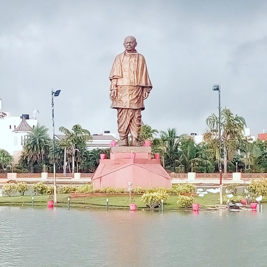 man statue near body of water during daytime in Surat India