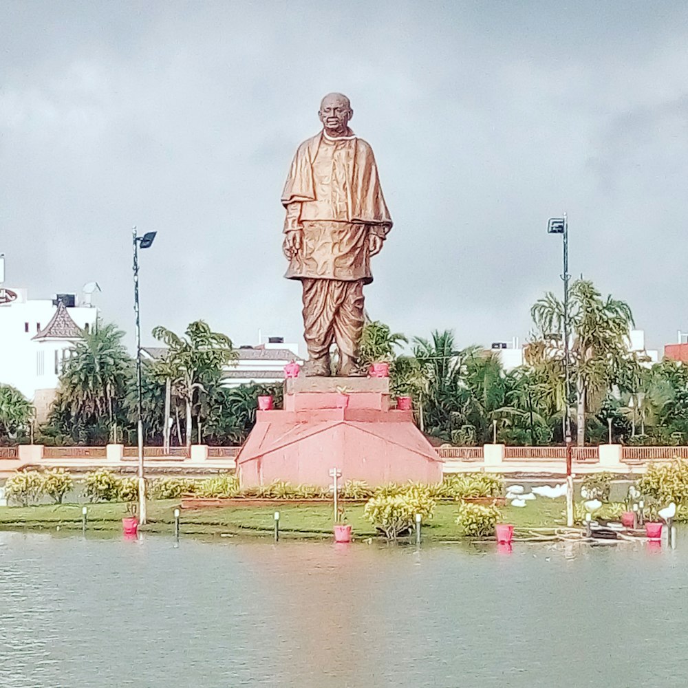 man statue near body of water during daytime