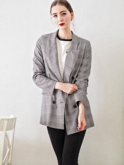 a lady dressed in an oversize blazer