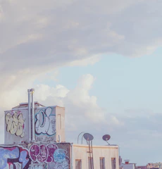 A lively rooftop painted in deep reds and oranges under a clear blue sky