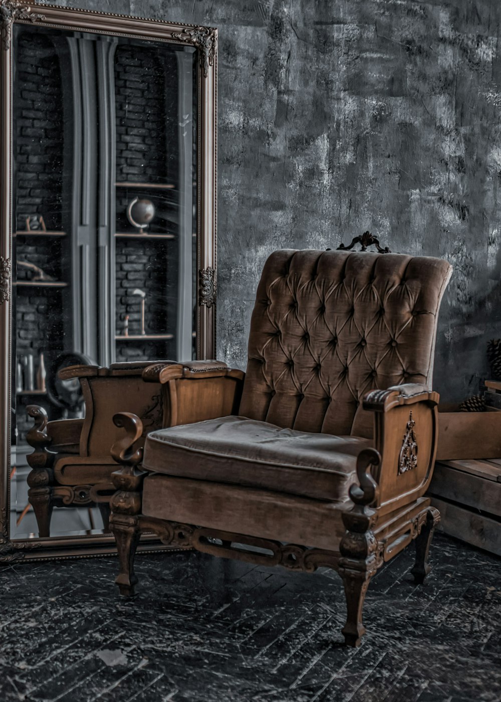 brown wooden armchair beside white wall