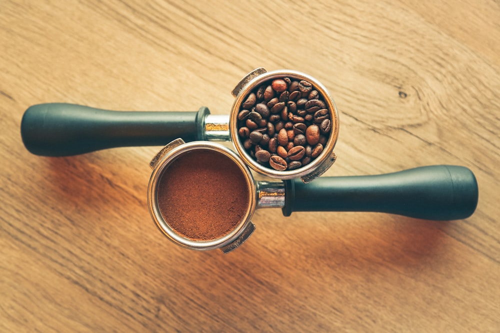 black and silver magnifying glass on brown wooden table