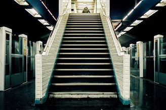 A user comfortably seated on the stairlift robot as it ascends a flight of stairs
