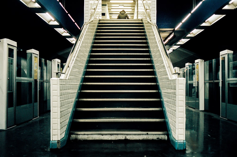 gray and blue staircase with blue railings